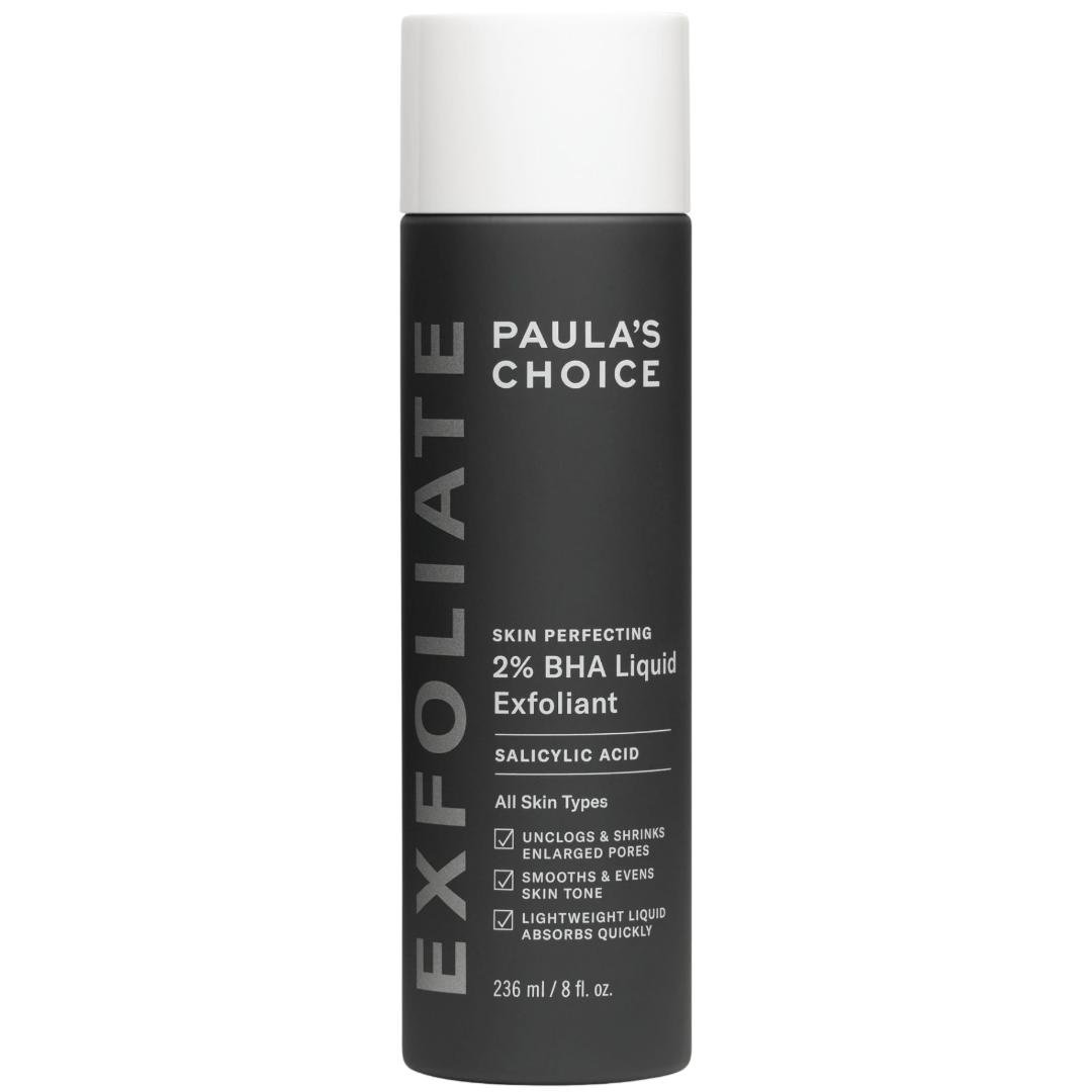 A black bottle of Paula’s Choice Skin Perfecting 2% BHA Liquid Exfoliant with white and grey text detailing its benefits. The label highlights its suitability for all skin types, featuring salicylic acid to unclog pores, smooth skin tone, and provide lightweight, fast-absorbing hydration.