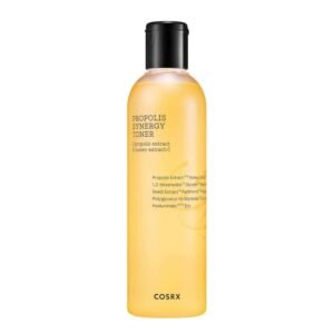 Clear glass bottle of COSRX Propolis Synergy Toner (150ml) on white background, showcasing golden-hued liquid. Text highlights "72.6% Propolis Extract" and "10% Honey." Ideal for dry, sensitive, or acne-prone skin in humid climates. Fast-absorbing, non-sticky formula for hydration and redness reduction.