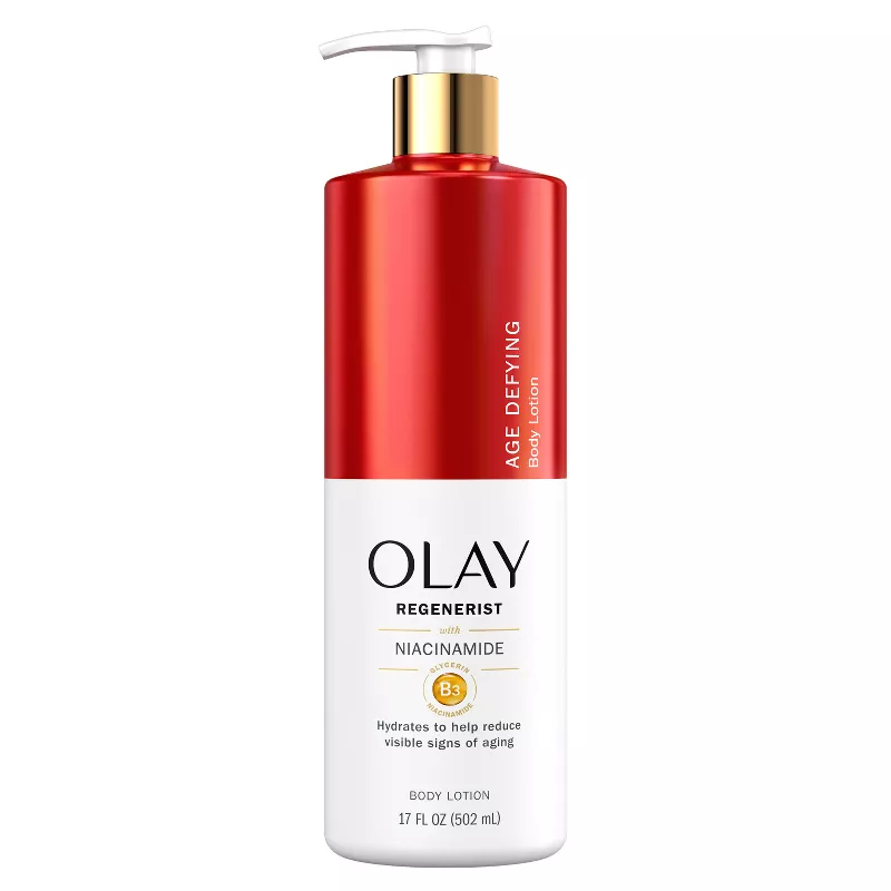 Front-facing photo of a 17 fl oz pump bottle of OLAY Regenerist Niacinamide Body Lotion on a clean white background; the red-and-silver label highlights “Niacinamide” and “Vitamin B3 Complex,” conveying a premium, age-defying body moisturiser.