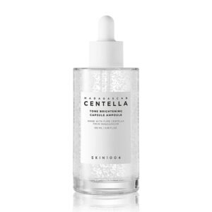 SKIN1004 Madagascar Centella Tone Brightening Capsule Ampoule 50ml—clear bottle with dropper, containing a lightweight, transparent serum with micro-beads, designed to brighten and soothe skin.